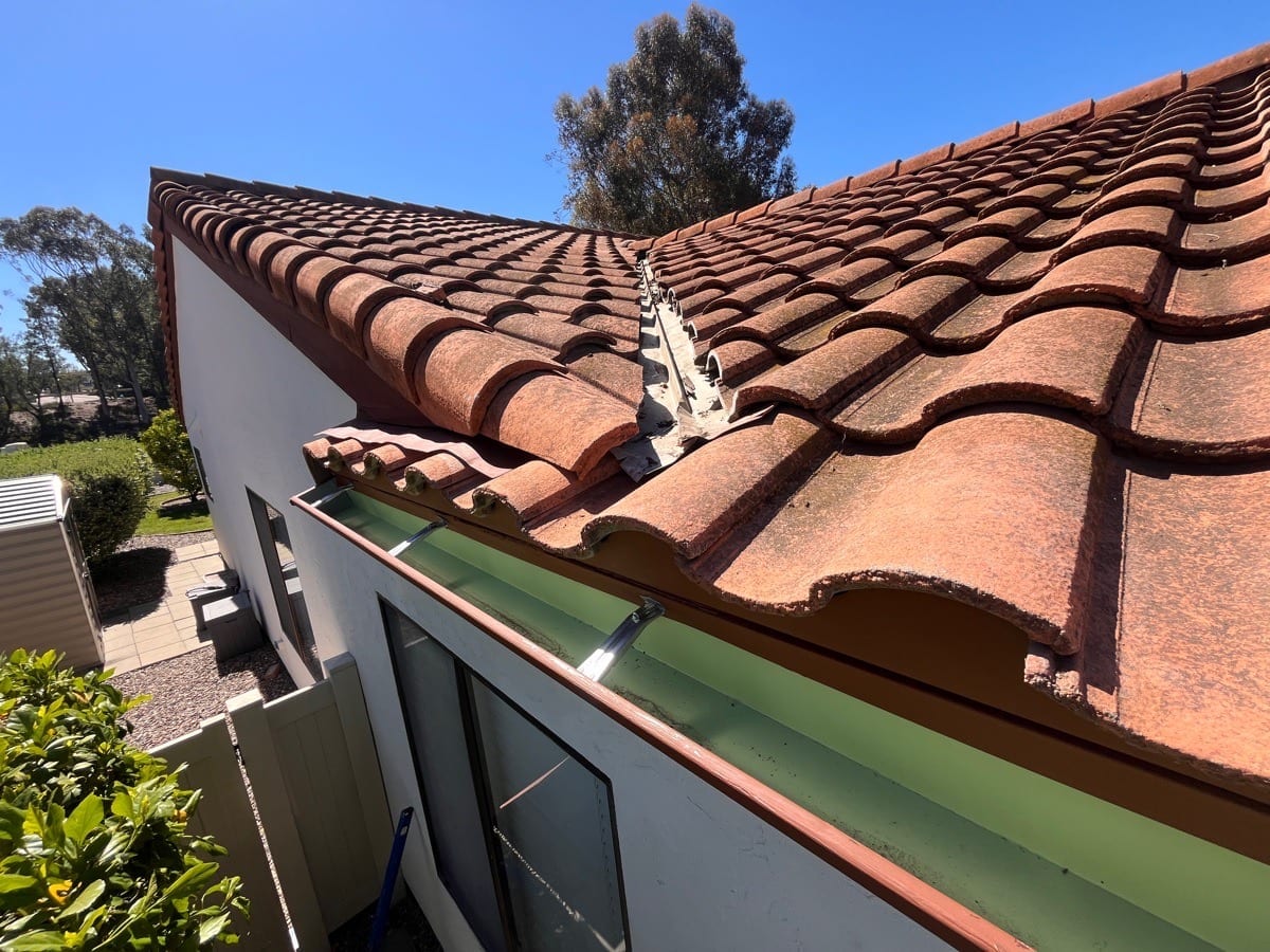 Completed rolled gutter and roof-edge work documented on an AWC project
